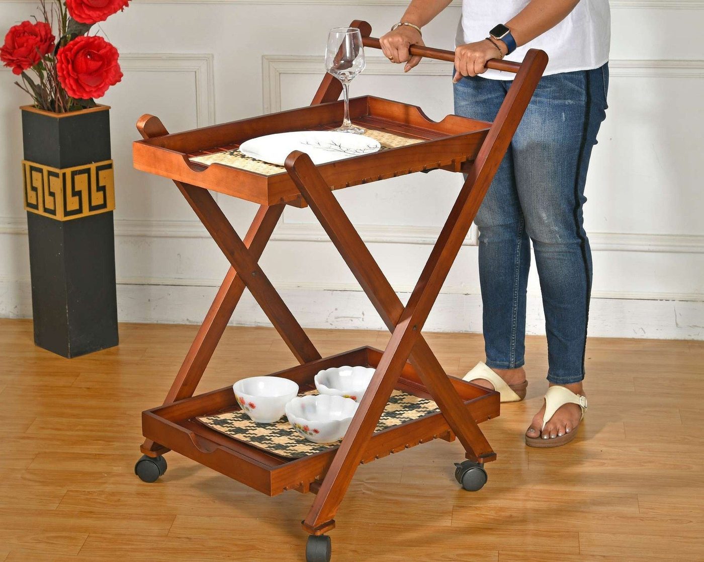 Bar trolley in use, laid with glasses and flowers