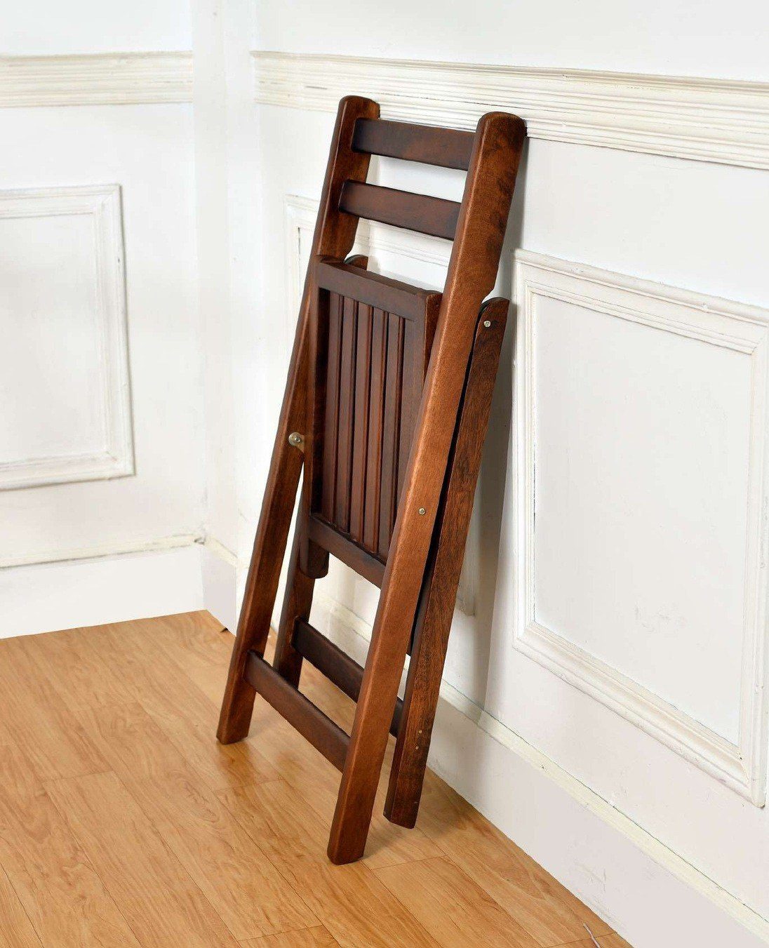 Folding chair folded flat against a wall